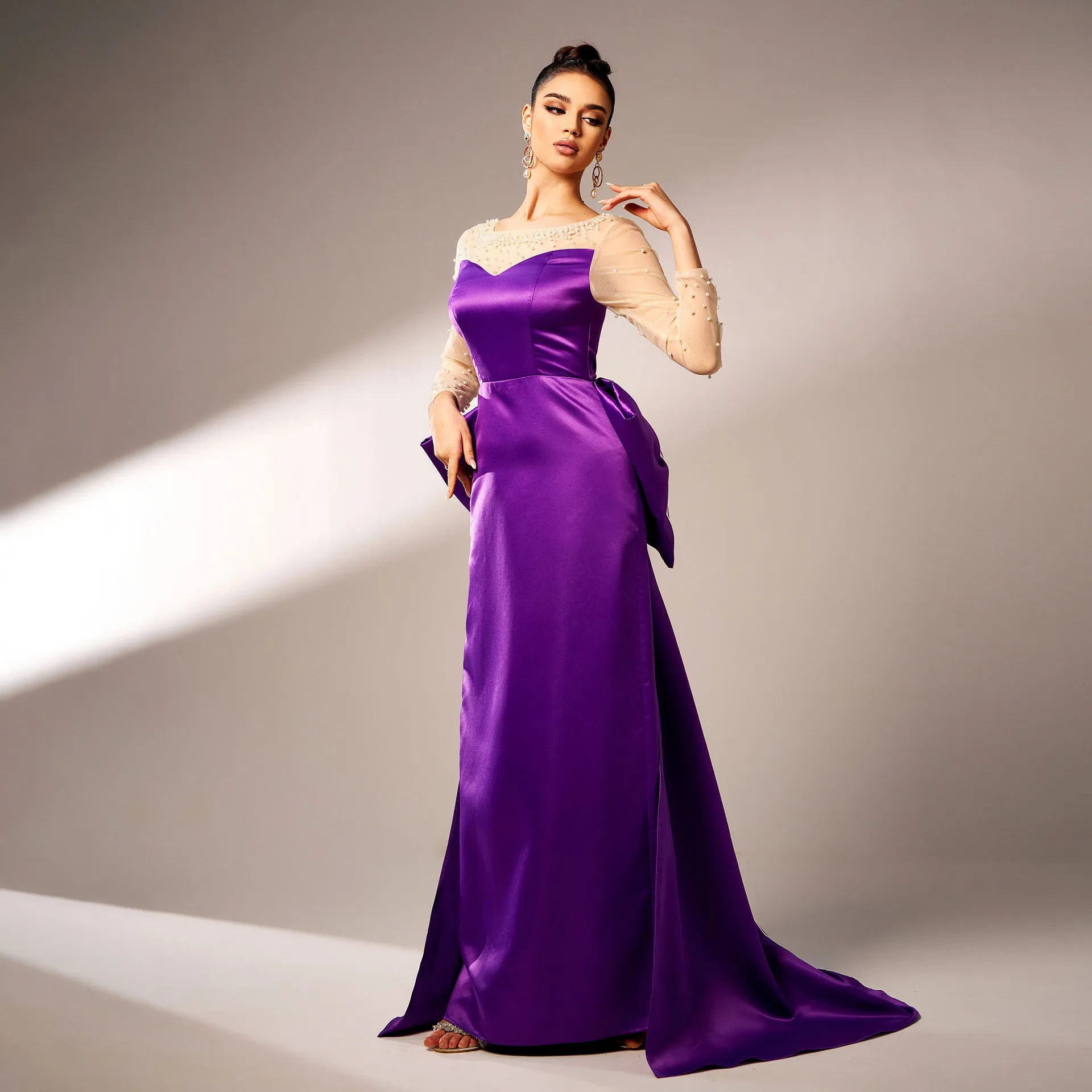 Elegant Beaded Long-Sleeve Bow-Detail Evening Gown with Dramatic Flair