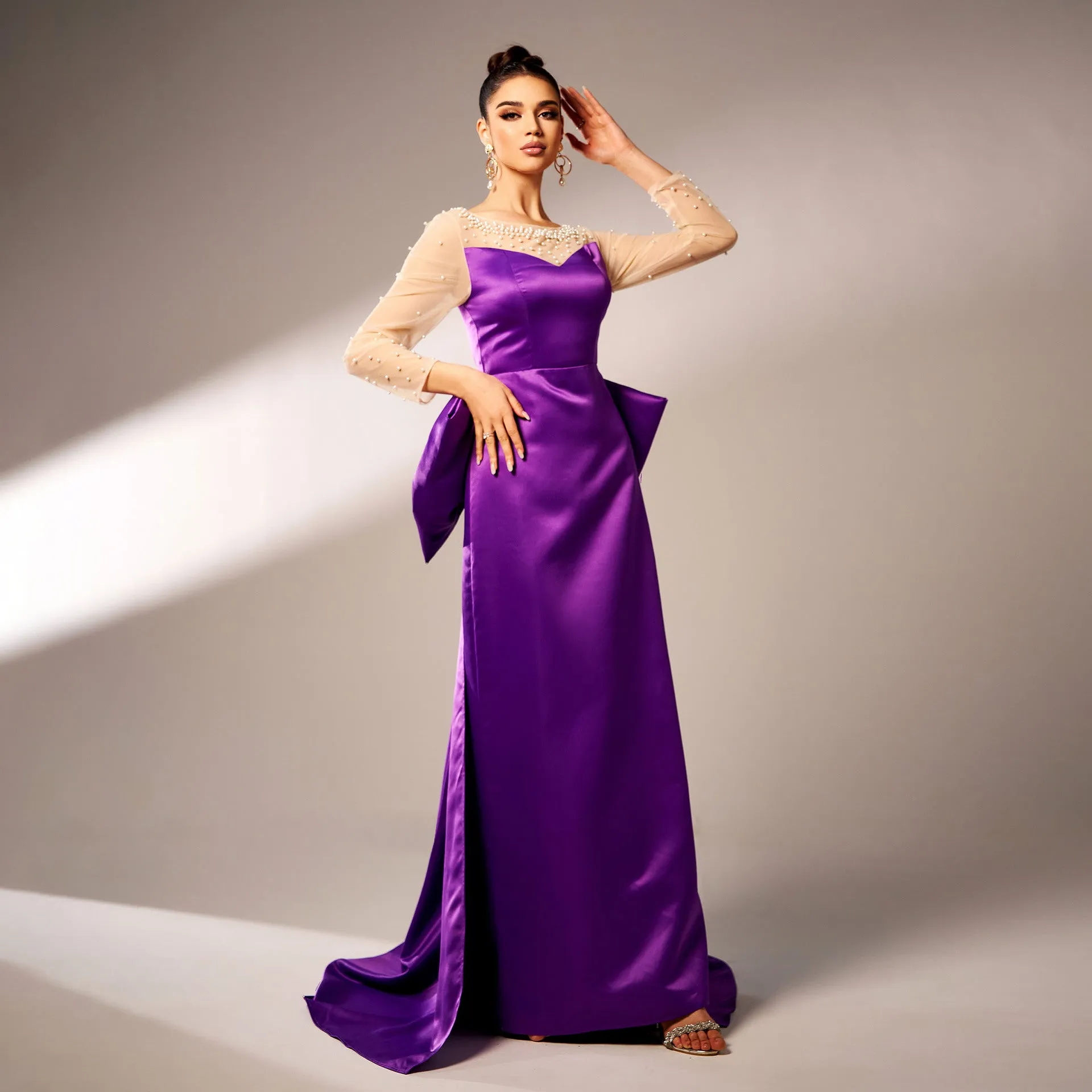 Elegant Beaded Long-Sleeve Bow-Detail Evening Gown with Dramatic Flair