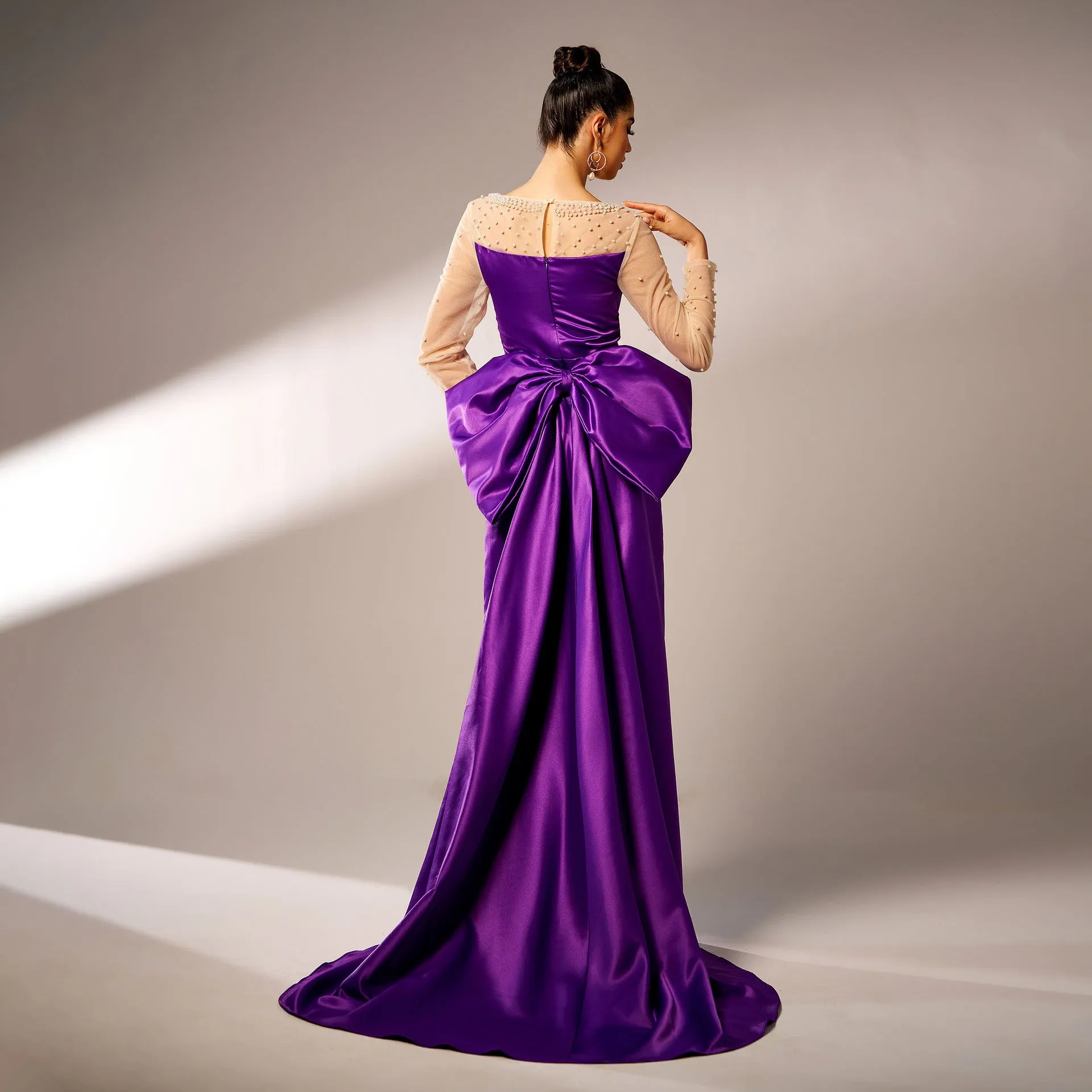 Elegant Beaded Long-Sleeve Bow-Detail Evening Gown with Dramatic Flair