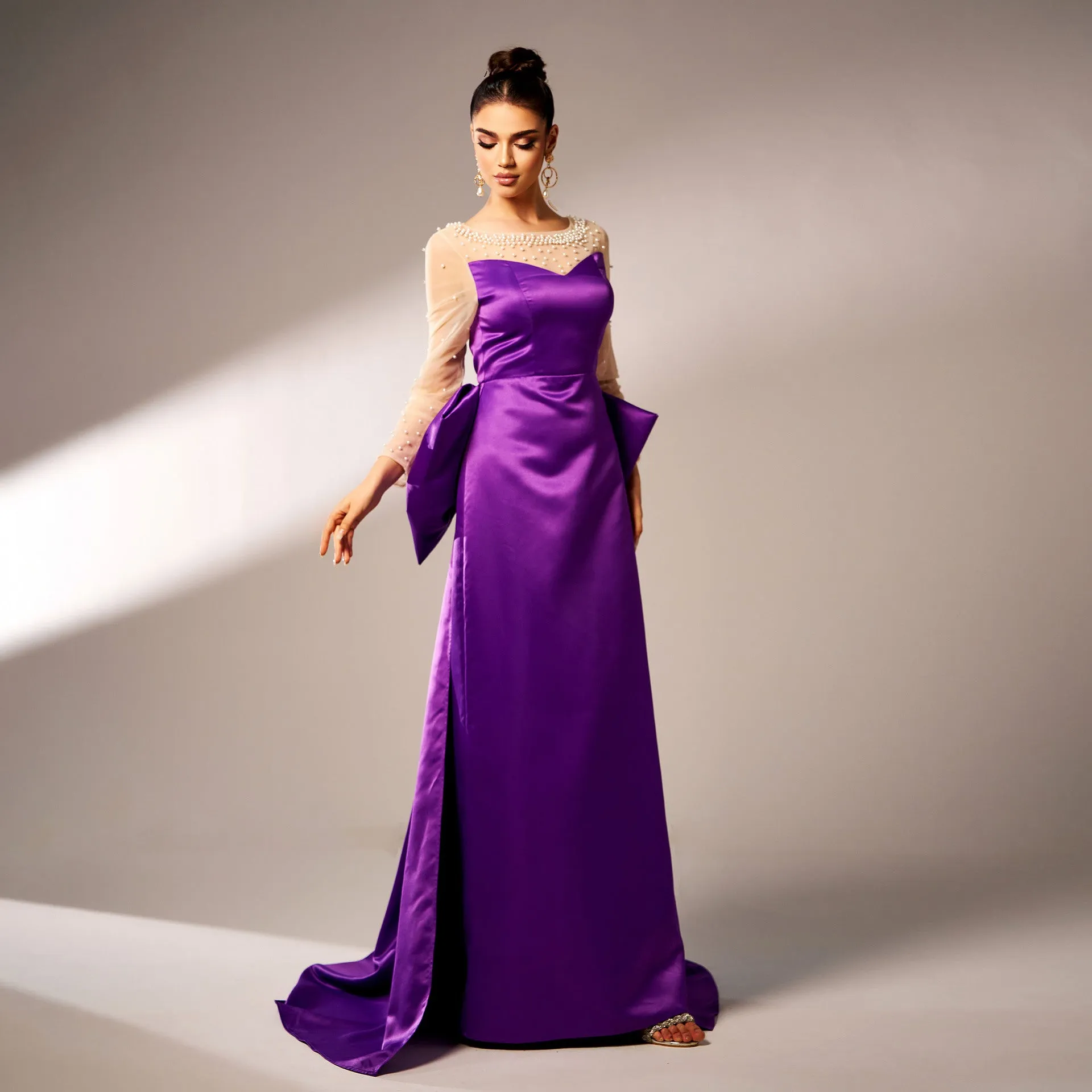 Elegant Beaded Long-Sleeve Bow-Detail Evening Gown with Dramatic Flair