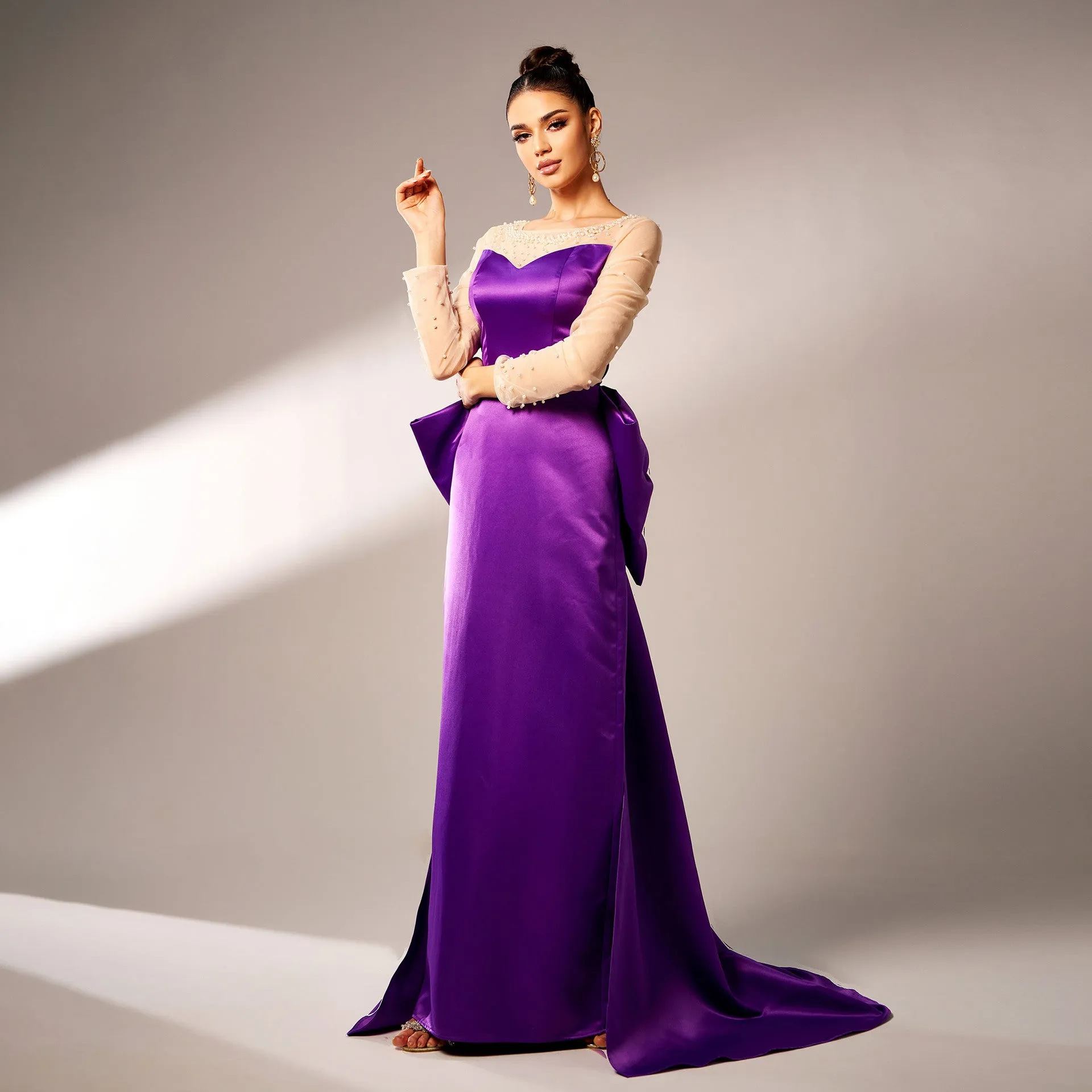 Elegant Beaded Long-Sleeve Bow-Detail Evening Gown with Dramatic Flair